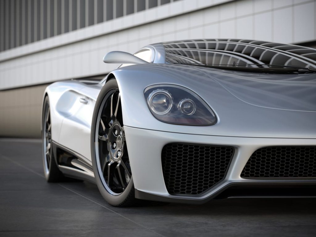 A silver sports car on black tile floor