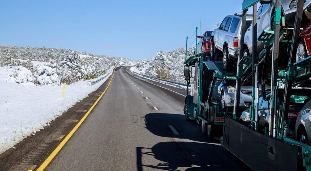 Truck transporter cars carrier at the road winter in the mountains