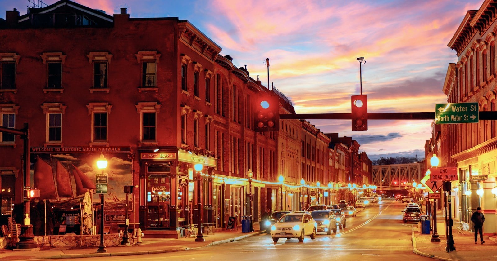 Lit brick blocks of Washington Street in South Norwalk, Connecticut at dusk