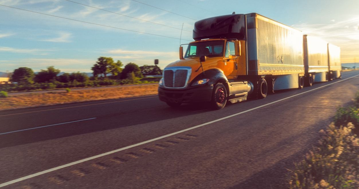 Semi truck on a Colorado highway at sunset