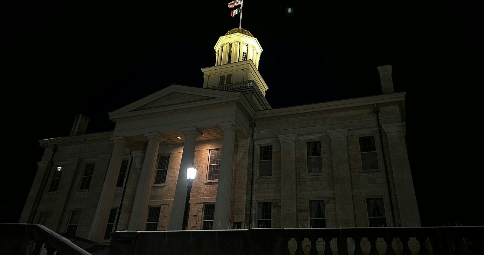 The Old Capitol's gold dome lit at night in Iowa City, Iowa