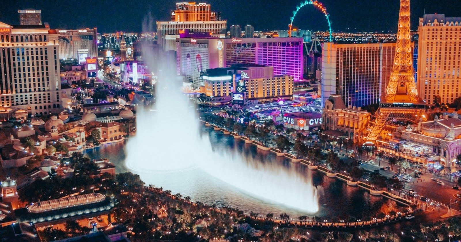 Bellagio fountain show and Strip resorts at night in Paradise, Nevada