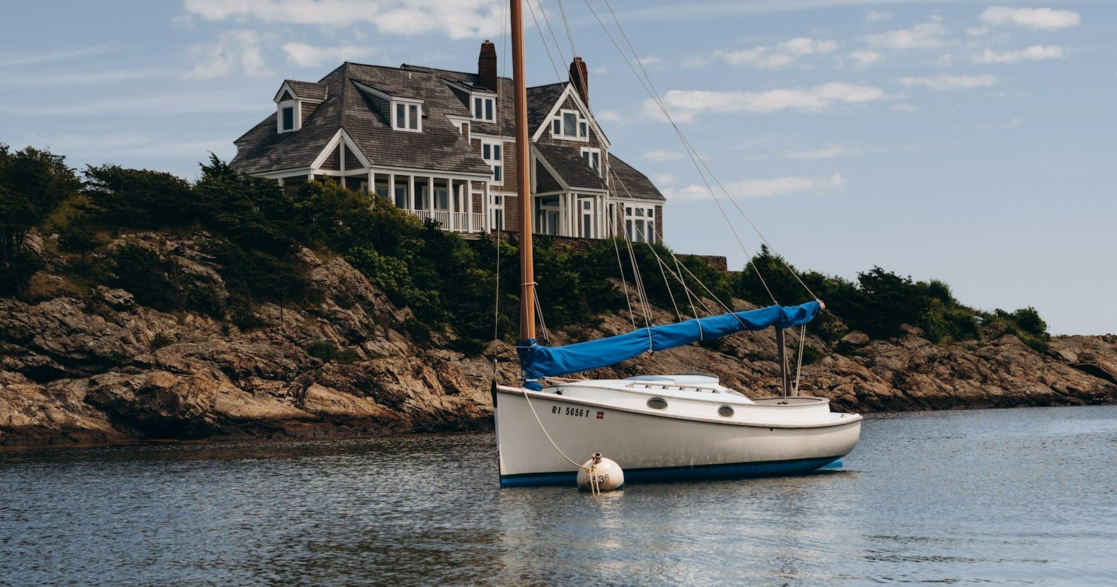 Catboat in a rocky Newport cove