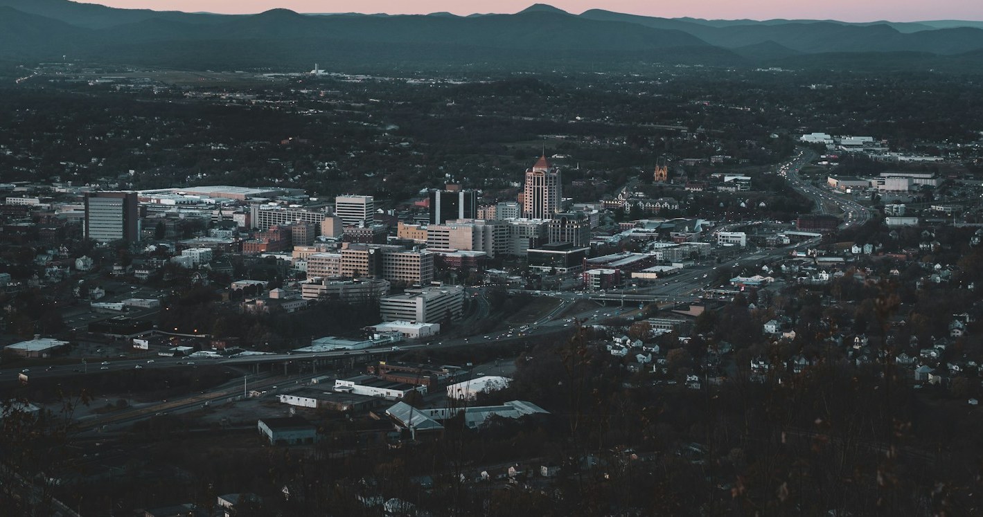 Downtown Roanoke at dusk with the Blue Ridge mountains behind