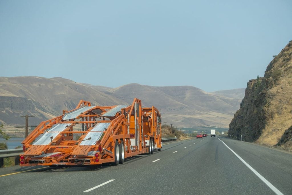 Car carrier on the freeway in the wilderness