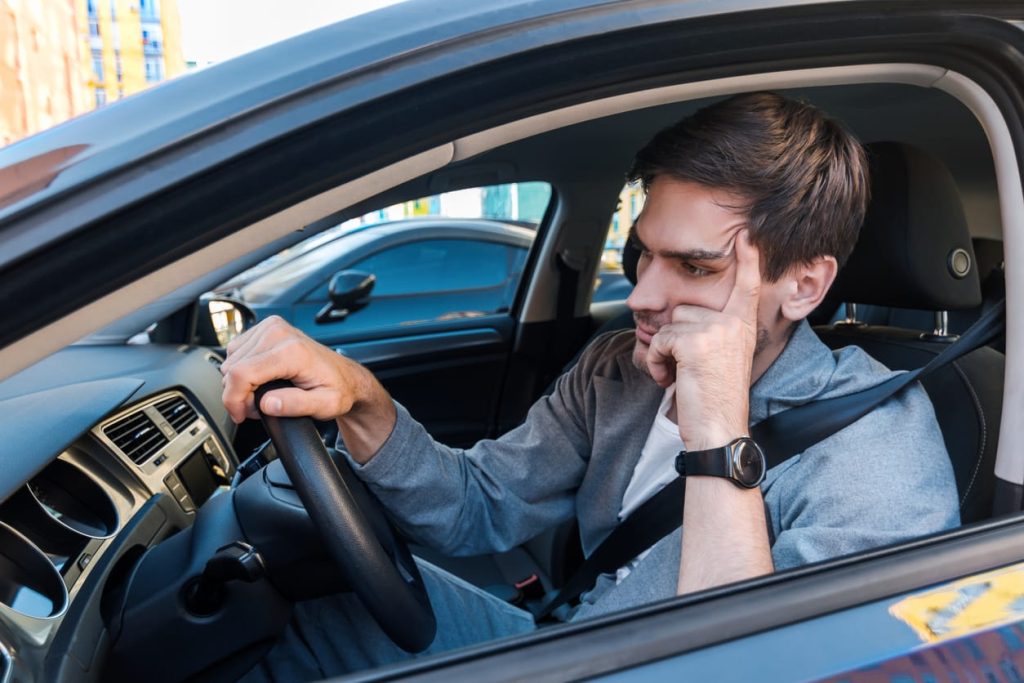 Annoyed buisnessman in car late for meeting