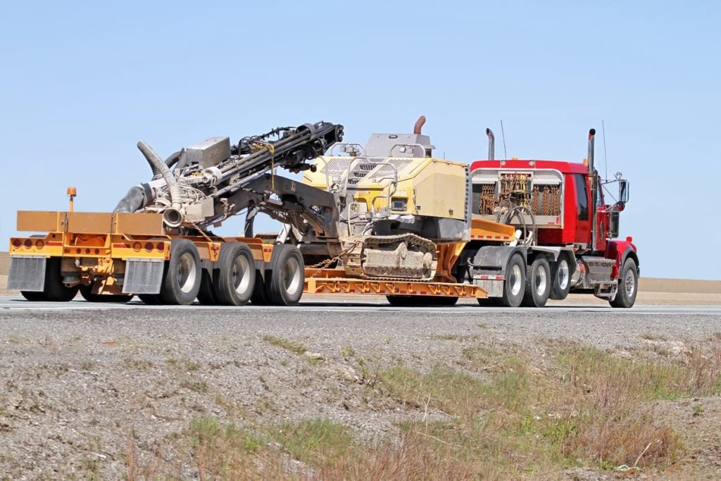 Semi Flatbed Truck Transporting A Portable Drilling Rig
