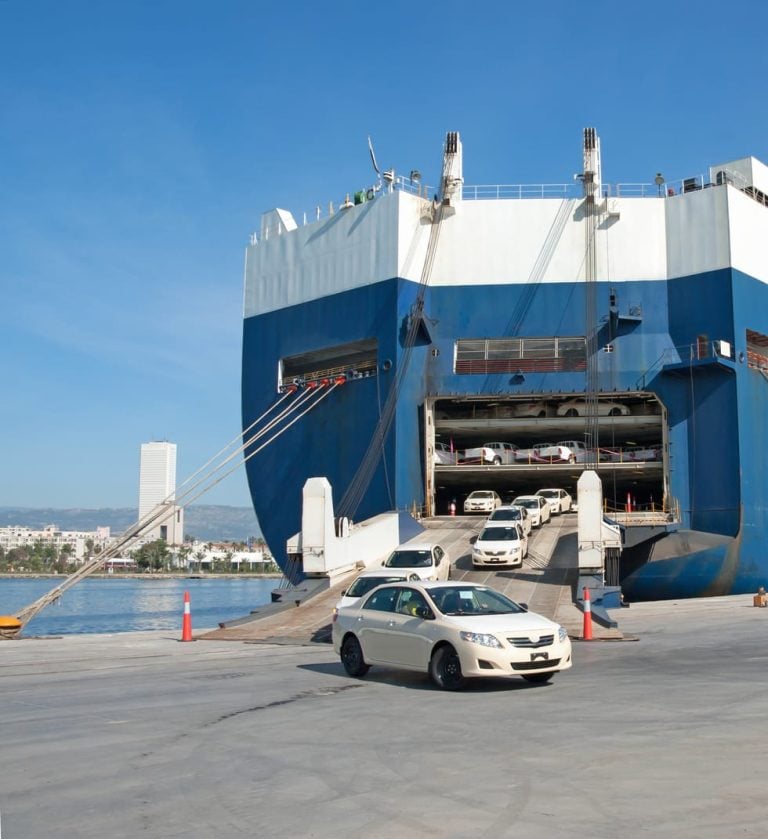 Vehicle driving off a roll-on roll-off vessel at a port