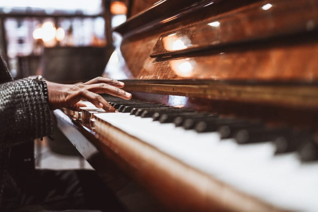 African Male Gently Playing The Piano