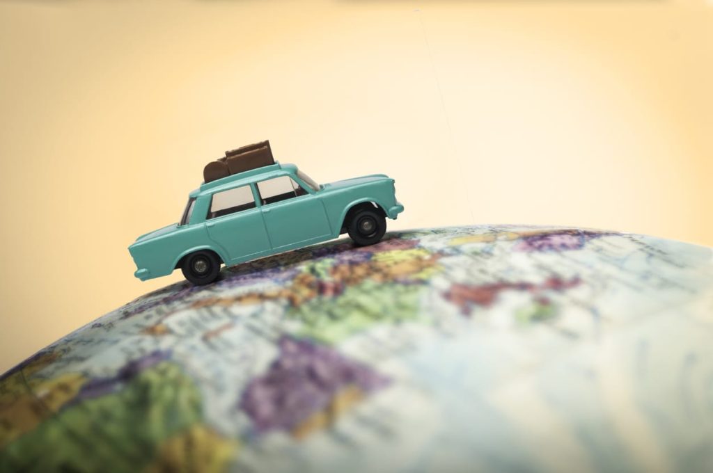 Vacationing toy car on a globe
