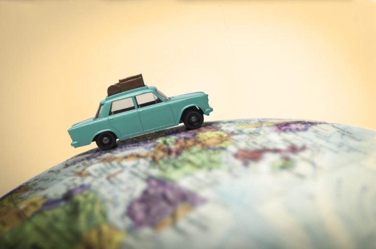 Vacationing toy car on a globe