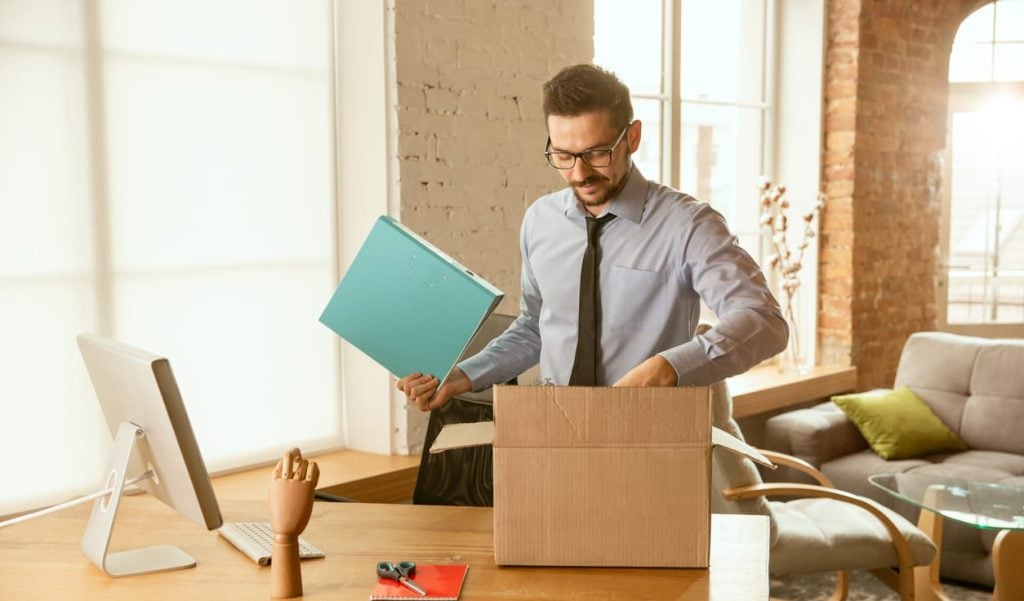 A young businessman moving in office, getting new work place