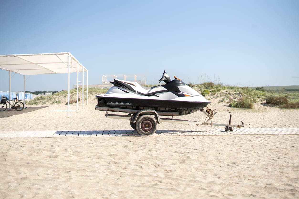 jetski sport water bike on the trailer on the sandy beach on vacation