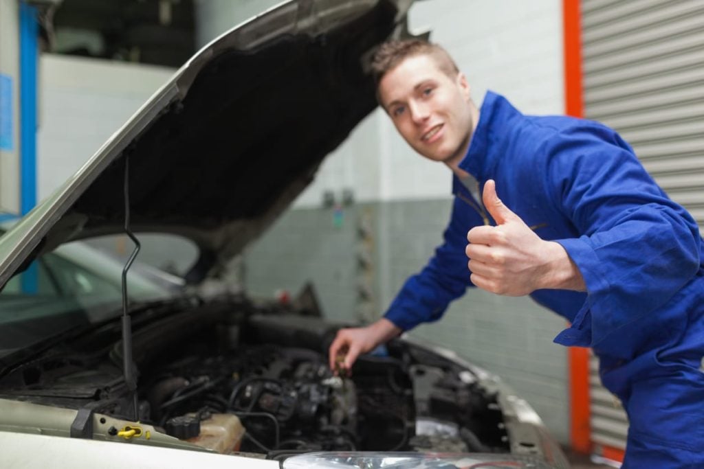Mechanic gesturing thumbs up
