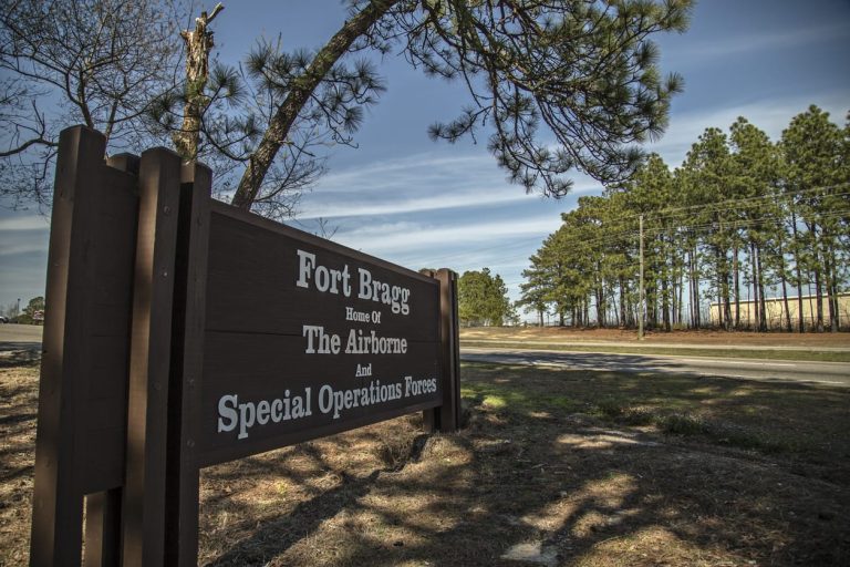 Fort Bragg entrance sign among pines