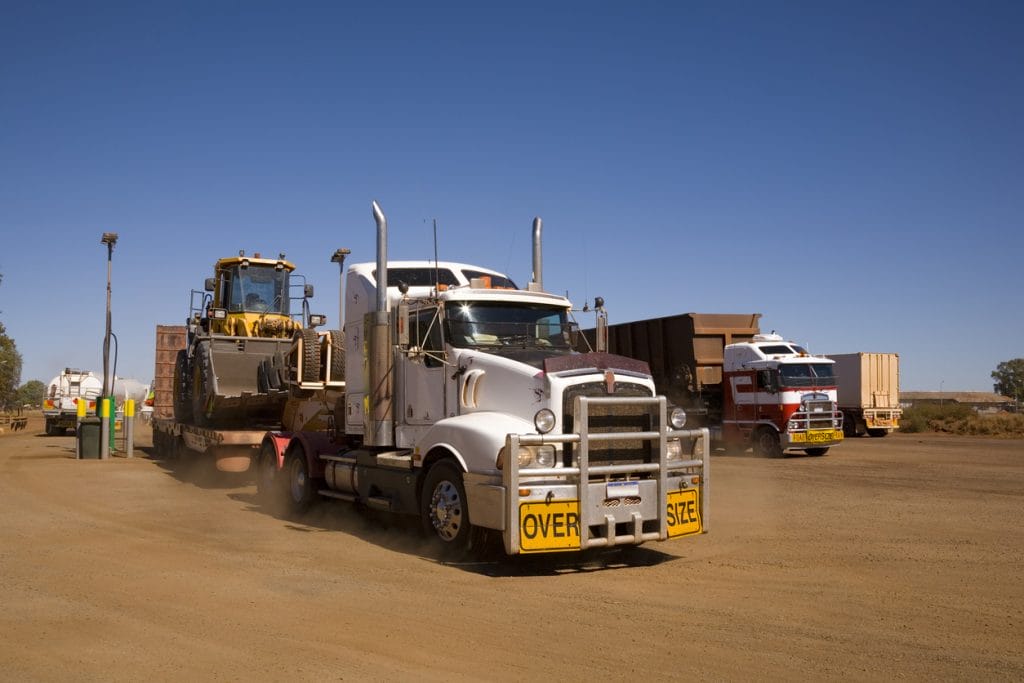 Heavy haul truck carrying equipment through the desert