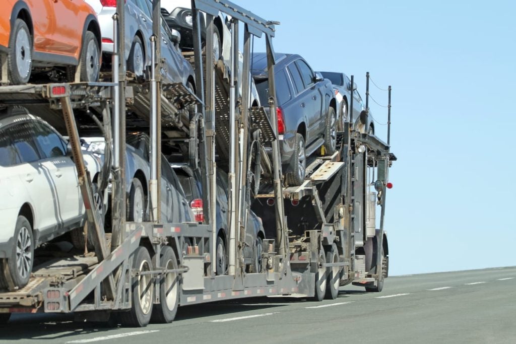 Semi Truck Vehicle Transporter Travelling A Highway With Full Load
