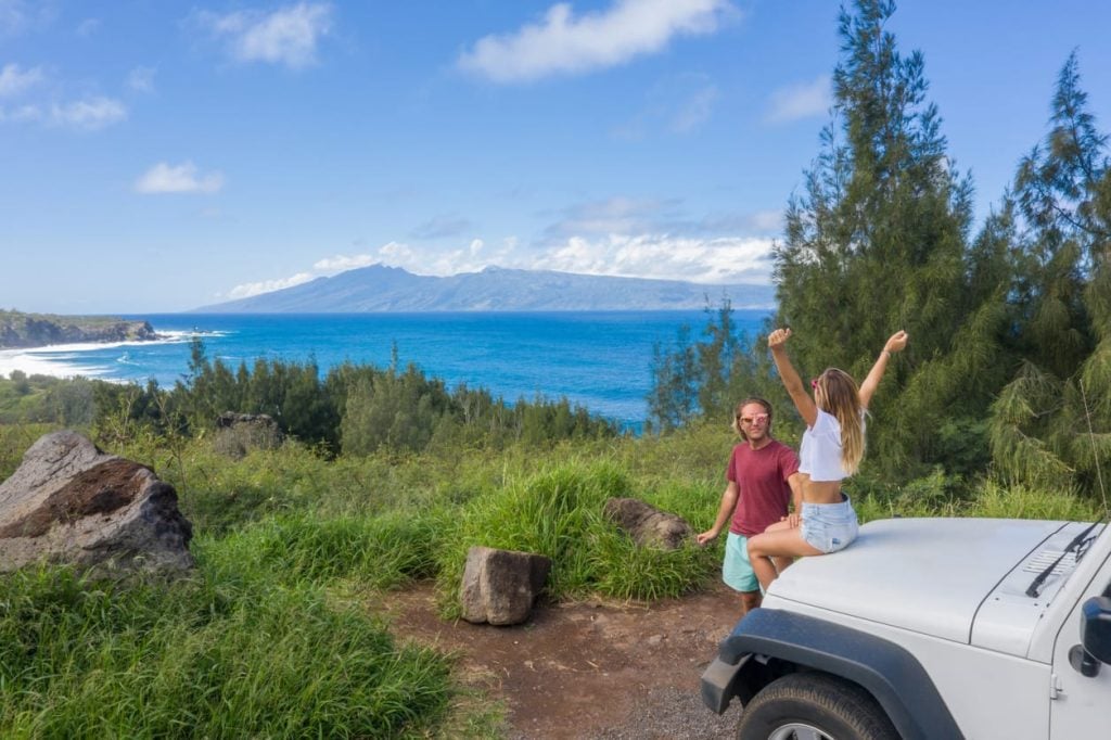 Couple beside a Jeep at a Hawaii coastal overlook