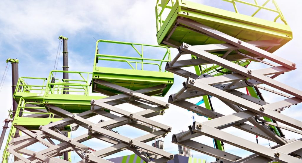 Construction scissor lifts on sky