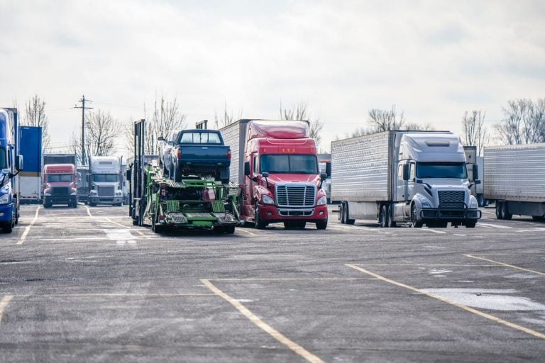 Conventional tractors parked in a row at a terminal