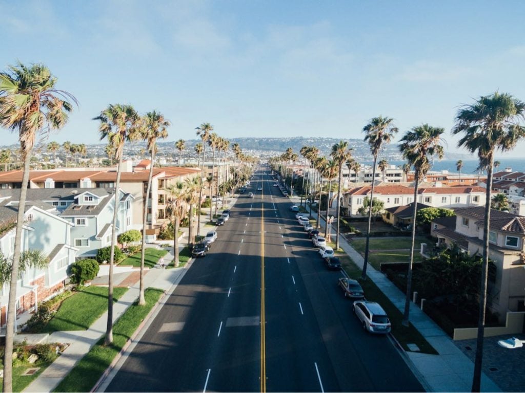 Palm lined street running down to the ocean in San Diego