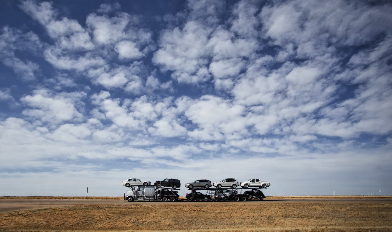 Car carrier crossing open country