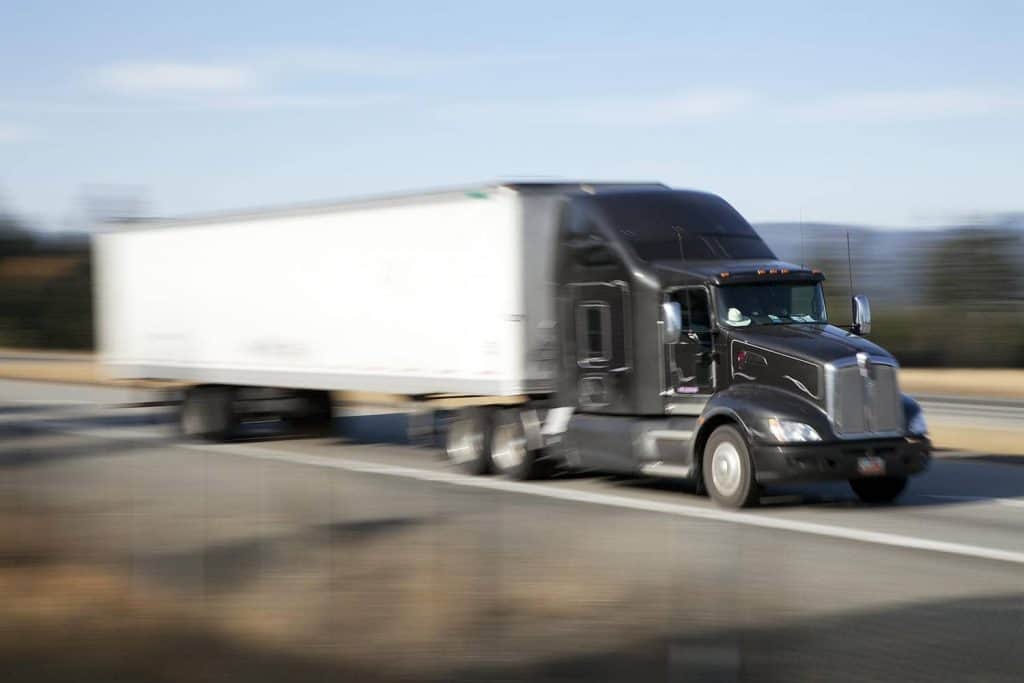 Semi truck and dry van running a highway