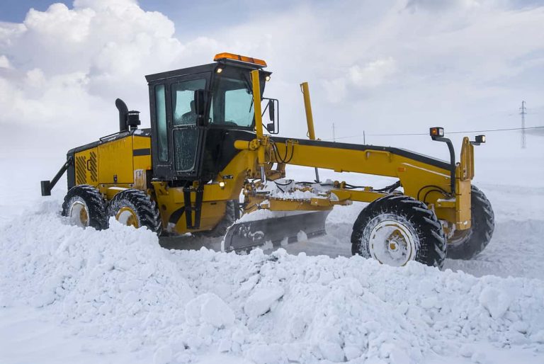 Construction machine trying to open the highway that was closed due to a snowstorm.