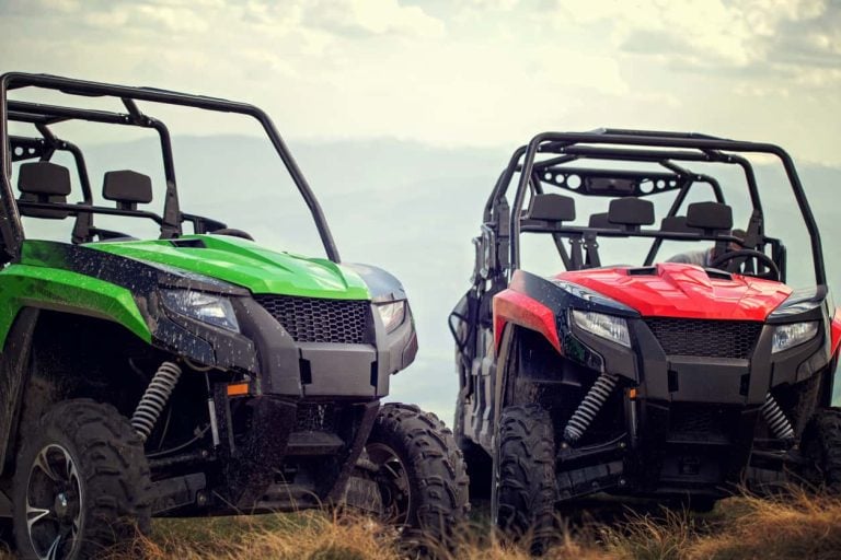 Friends driving off-road with quad bike or ATV and UTV vehicles