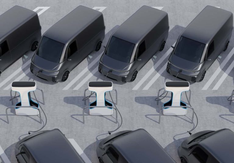 Fleet of Electric Delivery Vans charging in charging station