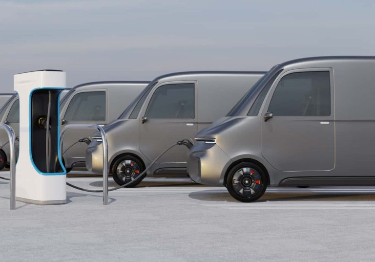 Fleet of Electric Delivery Vans charging in charging station