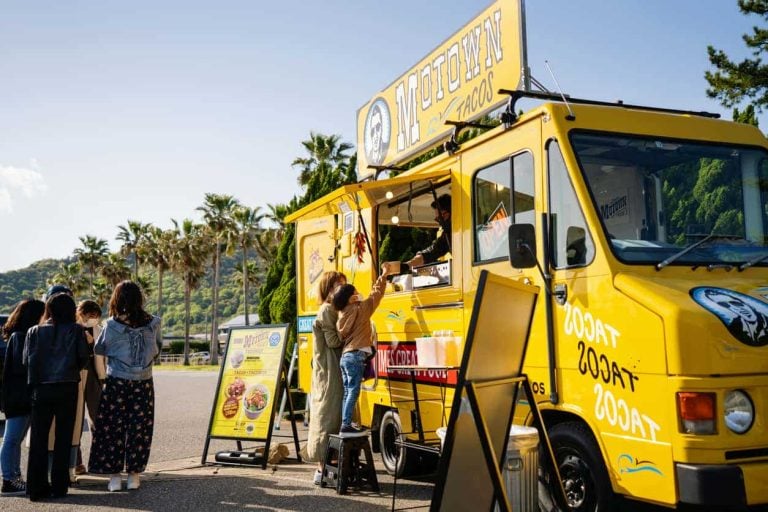Young boy buying lunch from a food truck