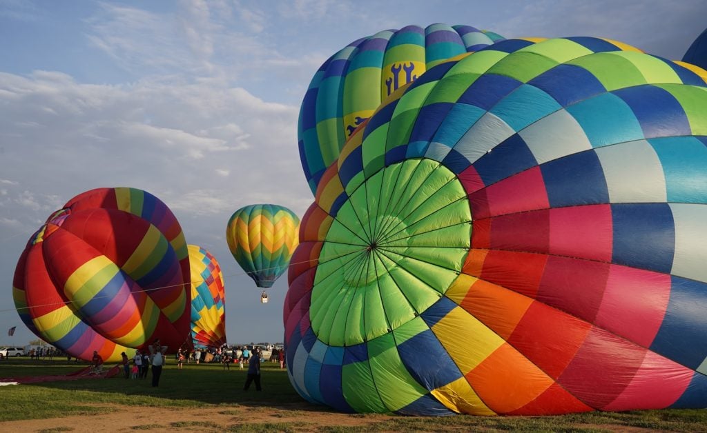 Colorful hot air balloons inflating on a field near Alamogordo and White Sands