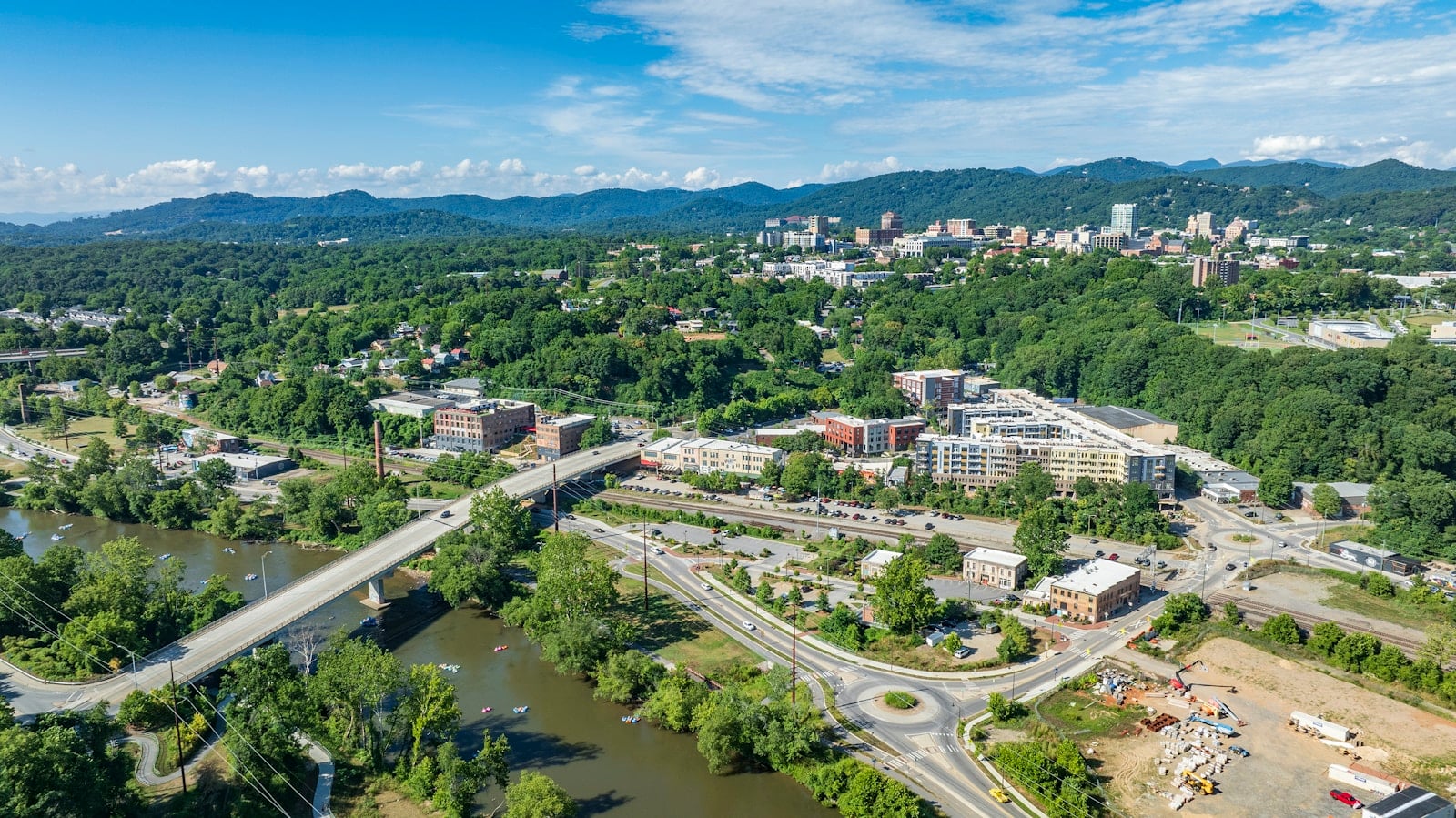 Aerial view of downtown Asheville with the Blue Ridge mountains behind