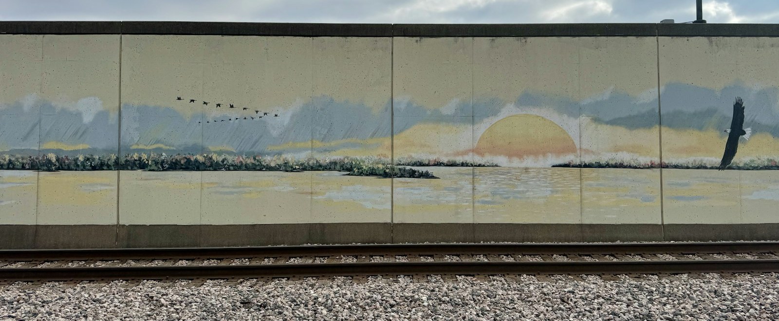 Painted floodwall mural along the railroad tracks in downtown Cape Girardeau, Missouri