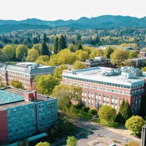 Aerial view over Oregon State University buildings with the Coast Range behind