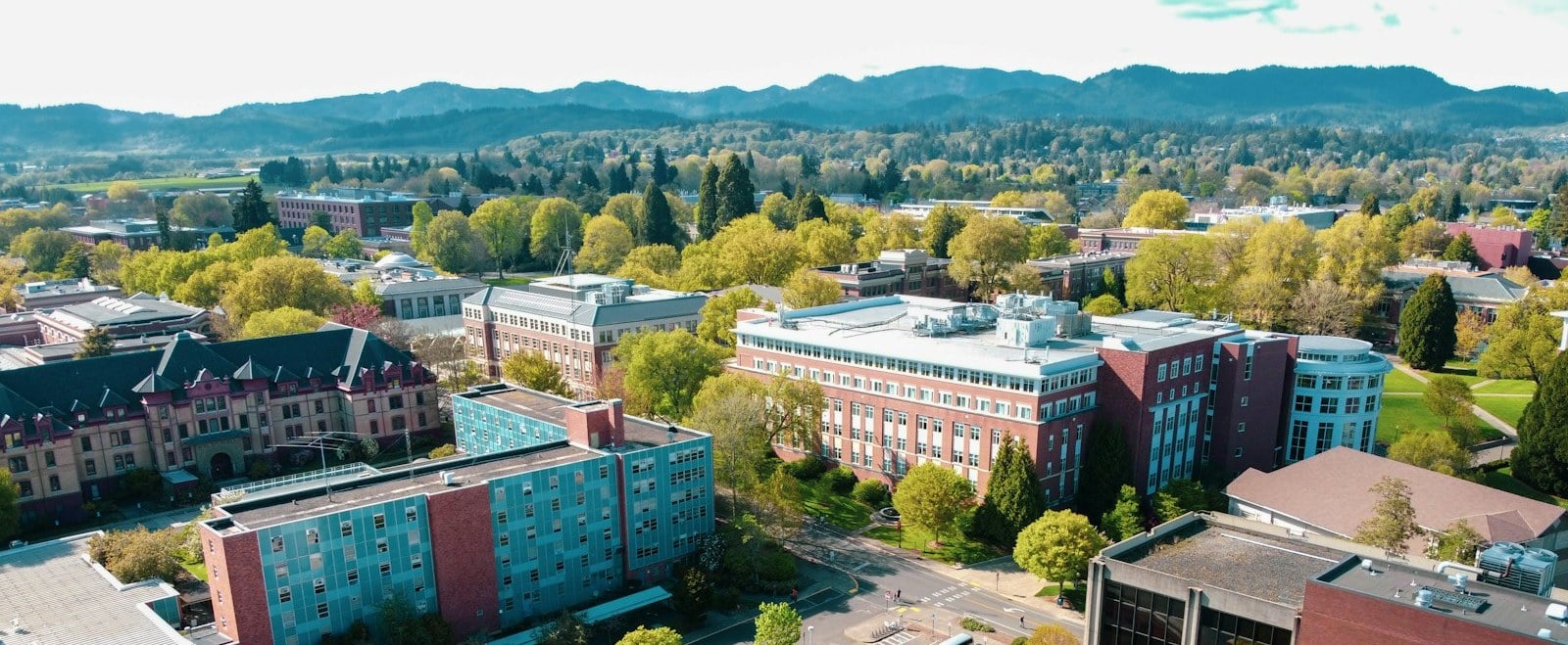 Aerial view over Oregon State University buildings with the Coast Range behind