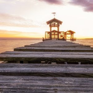 Wooden pier and pavilion at sunset in Ocean Springs, Mississippi