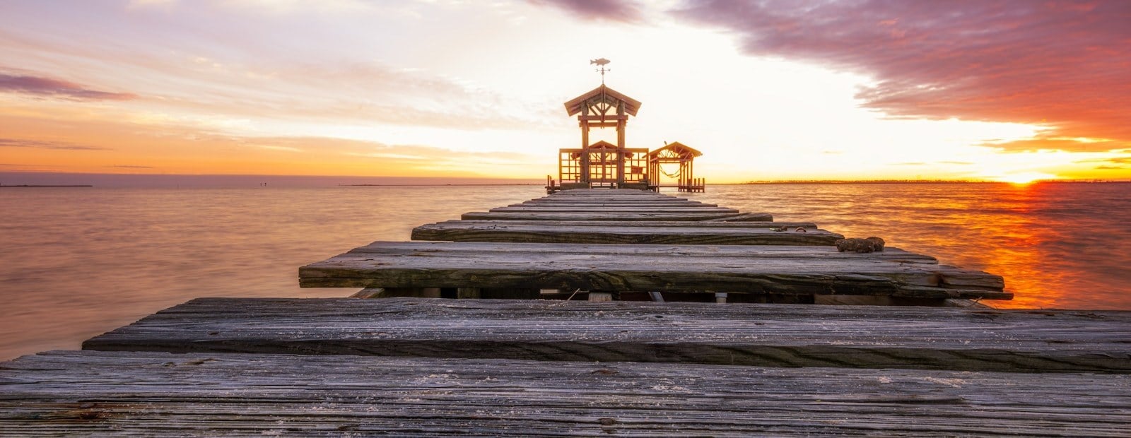 Wooden pier and pavilion at sunset in Ocean Springs, Mississippi