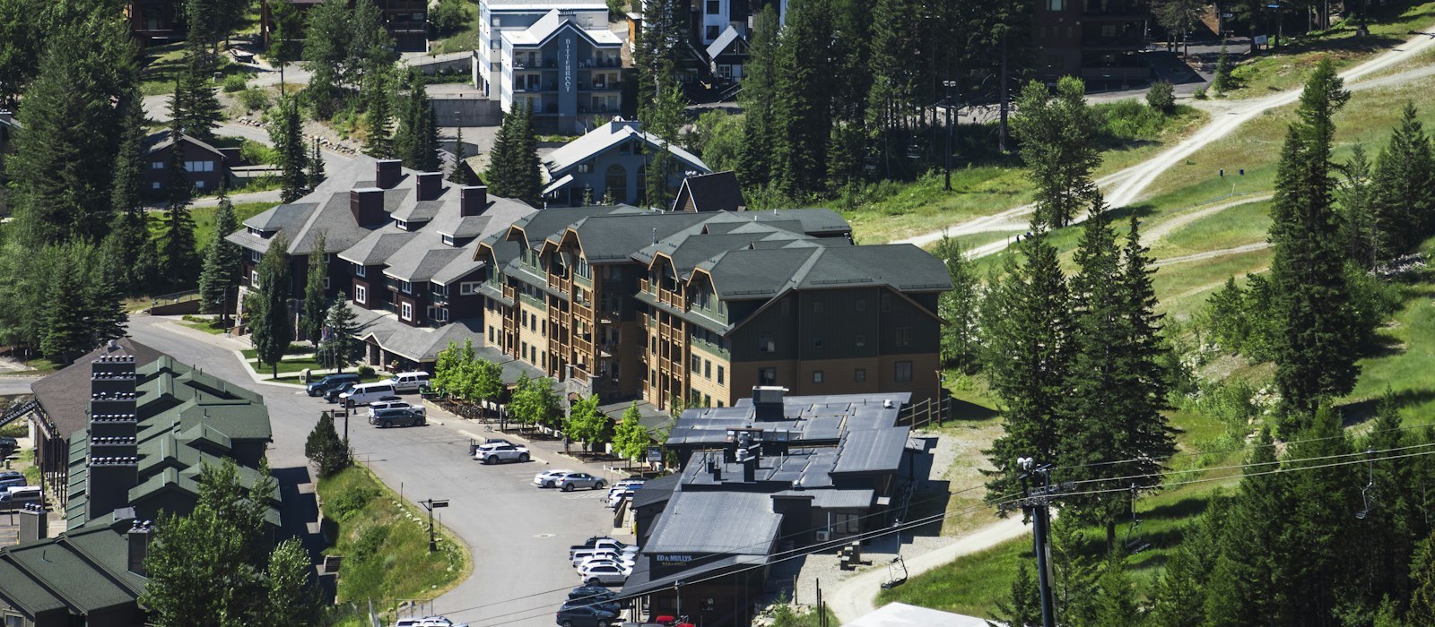 Lodges and parking of the Whitefish Mountain Resort village in summer