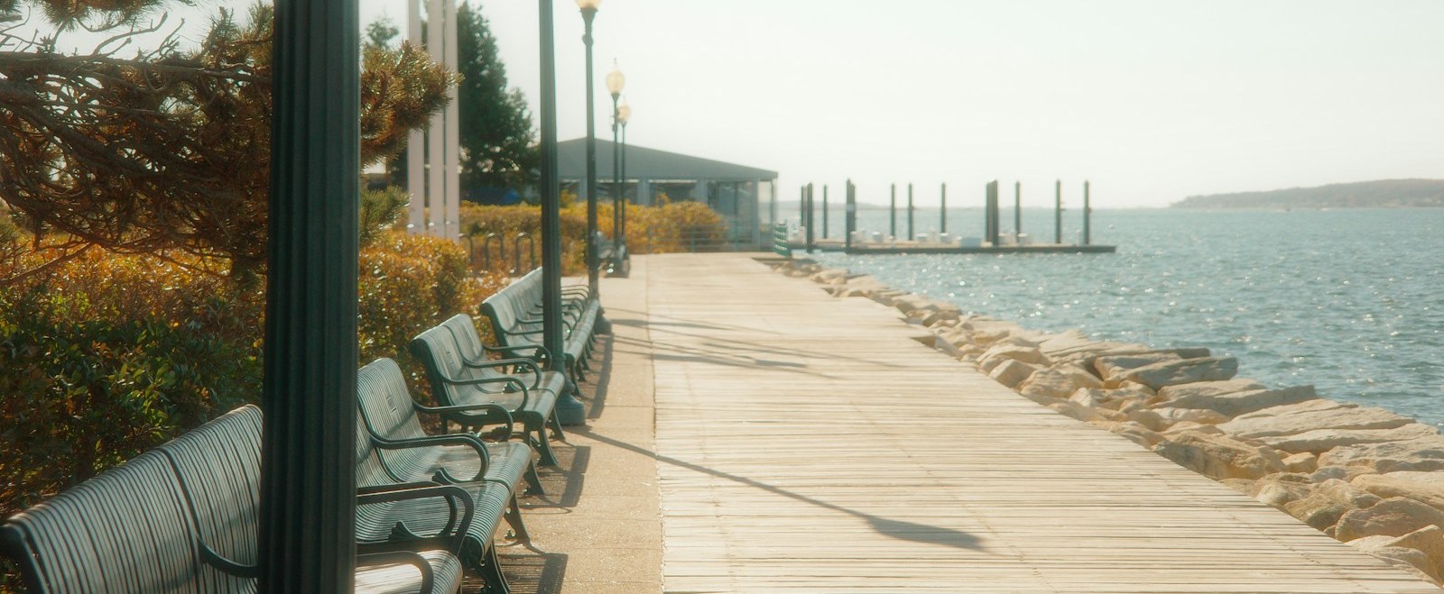 Benches along the Independence Park waterfront boardwalk on Bristol Harbor in Bristol, Rhode Island