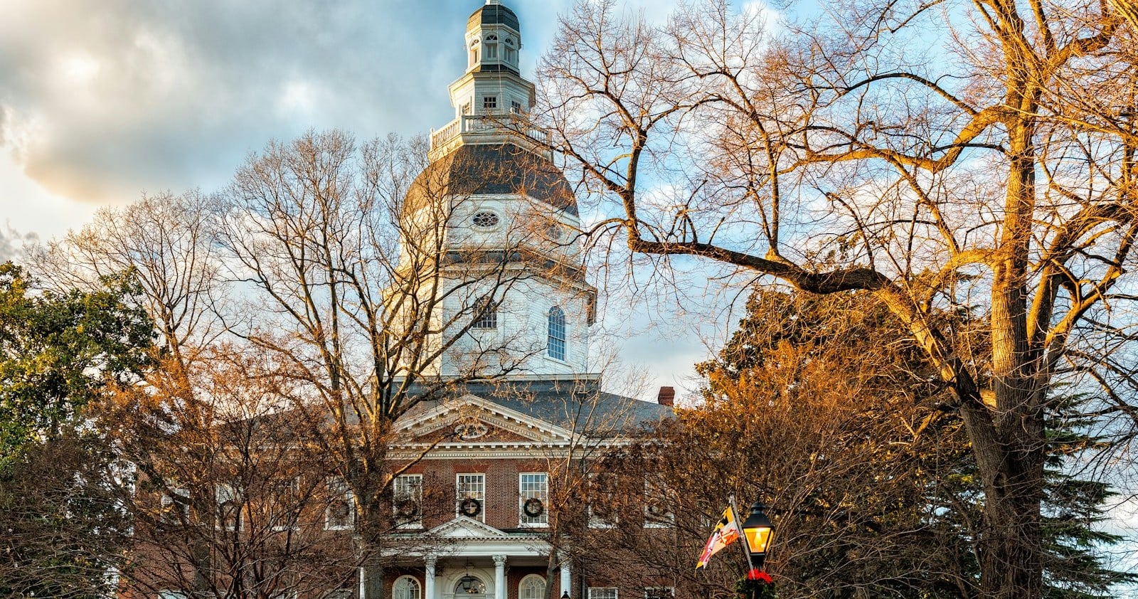 The Maryland State House dome above autumn trees in Annapolis, Maryland