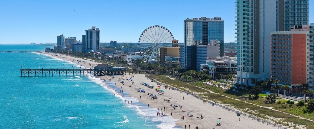 Aerial view of the Myrtle Beach oceanfront with the SkyWheel, pier, and hotel skyline in South Carolina