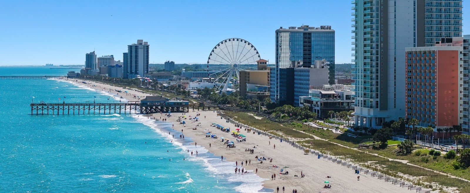 Aerial view of the Myrtle Beach oceanfront with the SkyWheel, pier, and hotel skyline in South Carolina