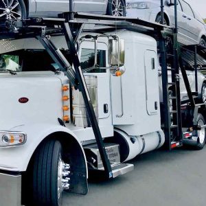 White semi car hauler loaded on the road