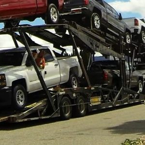 Pickups loaded on an open car carrier