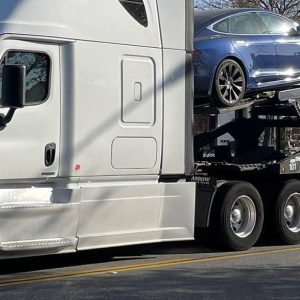 Car carrier loaded with sedans and SUVs
