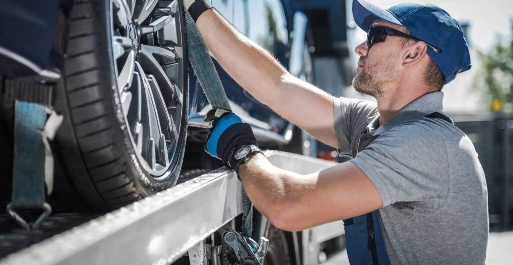 Carrier driver securing a wheel strap