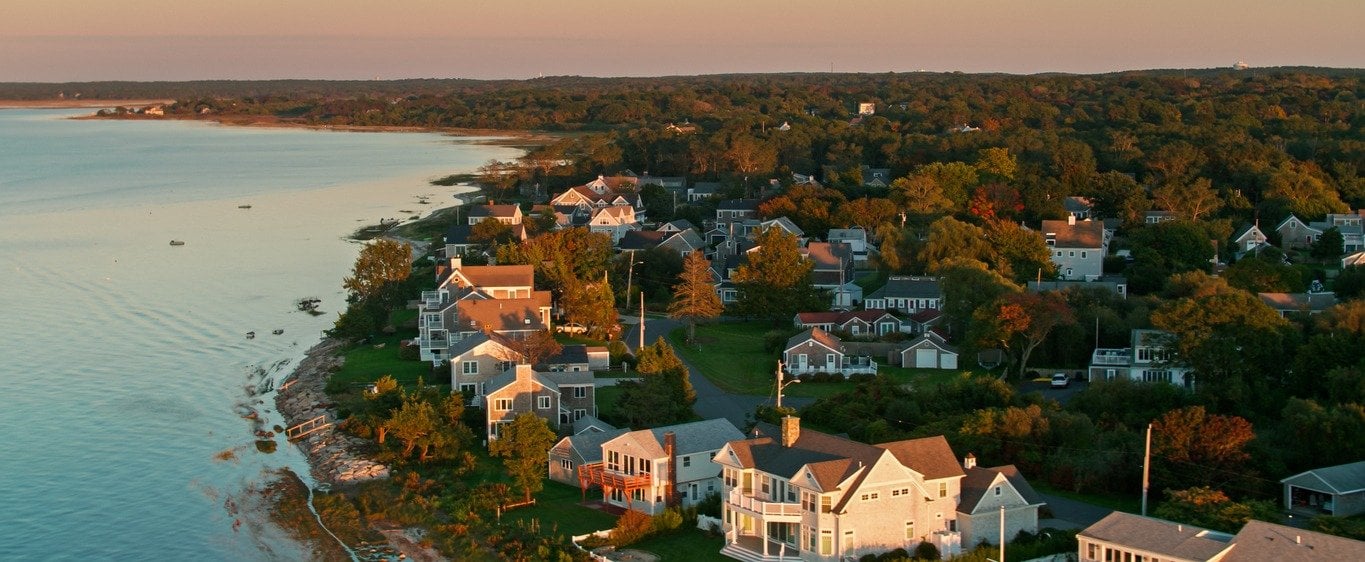 Aerial view of homes along the Cape Cod shoreline near Barnstable, Massachusetts at sunset
