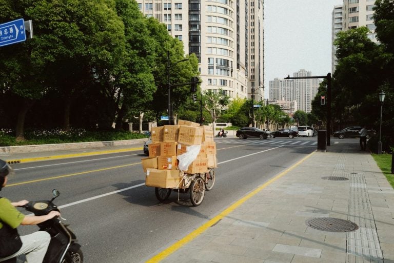 Cargo tricycle stacked with boxes on a city street